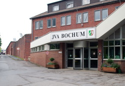 Rotes Backsteinhaus mit Haupteingang der Justizvollzugsanstalt Bochum mit Blumenkasten Rotes Backsteinhaus mit Haupteingang der Justizvollzugsanstalt Bochum mit Blumenkasten