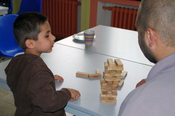 Vater und Kind sitzen an einem Tisch und spielen Vater und Kind sitzen an einem Tisch und spielen